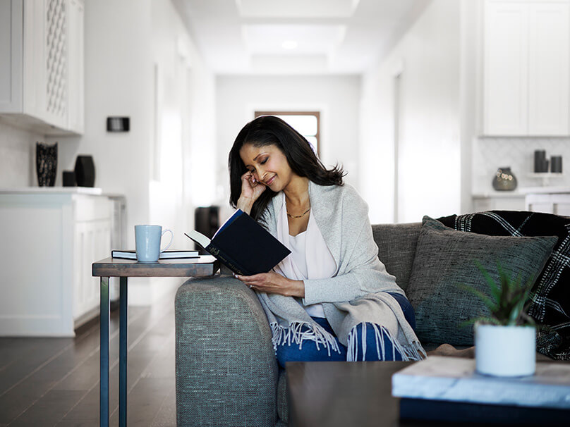 woman reading a book on the couch